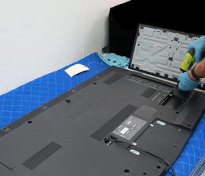 Electronics technician testing restored television equipment